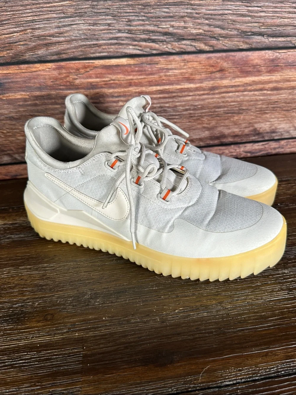 Nike Kids Light Gray Sneakers with Gum Sole and Orange Accents